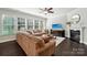 Cozy living room featuring hardwood floors, a fireplace, and large windows at 1805 Sutter Creek Dr, Waxhaw, NC 28173