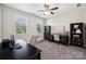 Well-lit office space with desk, chair, built-in shelving, and natural light at 1805 Sutter Creek Dr, Waxhaw, NC 28173