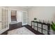 An open office space features dark wood flooring and ample storage with access to the home's staircase at 1805 Sutter Creek Dr, Waxhaw, NC 28173