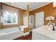 Bathroom with a soaking tub, glass shower, and modern fixtures at 1974 Links View Dr, Fort Mill, SC 29707