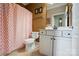 Traditional bathroom featuring a vanity with drawers, a toilet, and a pink patterned shower curtain at 1974 Links View Dr, Fort Mill, SC 29707