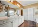 Bright bathroom features double vanity, large mirrors, and white cabinetry at 1974 Links View Dr, Fort Mill, SC 29707