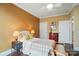 Bedroom with hardwood floors, white trim, two decorative lamps, and a bench at 1974 Links View Dr, Fort Mill, SC 29707