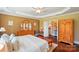 Well-lit bedroom with neutral walls, hardwood floors, and a spacious closet at 1974 Links View Dr, Fort Mill, SC 29707