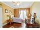 Bright bedroom with hardwood floors, a desk, and a large window for natural light at 1974 Links View Dr, Fort Mill, SC 29707