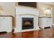 Close up of the white fireplace with built-in cabinets and mounted TV at 1974 Links View Dr, Fort Mill, SC 29707