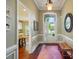 Inviting foyer with hardwood floors, trim detail, and a transom window above the front door at 1974 Links View Dr, Fort Mill, SC 29707