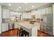 Bright kitchen with white cabinets, granite countertops, a center island, and stainless steel appliances at 1974 Links View Dr, Fort Mill, SC 29707