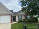 Charming single-story home boasts manicured lawn, brick accents, and attached garage for comfortable suburban living at 204 Woodbridge Cir, Mount Holly, NC 28120