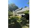 Image shows the backyard of the home with a large yard and green exterior at 20807 Willow Pond Rd, Cornelius, NC 28031