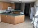 Outdated kitchen with wood cabinets, vintage appliances, and a breakfast bar peninsula at 20807 Willow Pond Rd, Cornelius, NC 28031
