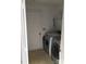 Small laundry room equipped with a modern washer and dryer, and access door to outside at 20807 Willow Pond Rd, Cornelius, NC 28031