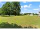 Large backyard with green grass and a storage shed at 233 Sellars Rd, Kings Mountain, NC 28086