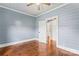 Bedroom with hardwood floors, shiplap walls, ceiling fan, and white trim at 233 Sellars Rd, Kings Mountain, NC 28086