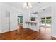 Open dining room with hardwood floors and views of the kitchen and backyard at 233 Sellars Rd, Kings Mountain, NC 28086