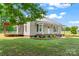 Beautiful home featuring a covered porch and deck, complemented by a lush green lawn at 233 Sellars Rd, Kings Mountain, NC 28086