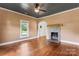 Inviting living room featuring hardwood floors and a stone fireplace, creating a cozy atmosphere at 233 Sellars Rd, Kings Mountain, NC 28086