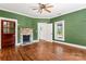 Cozy living room with hardwood floors, fireplace, and natural light from surrounding windows at 233 Sellars Rd, Kings Mountain, NC 28086