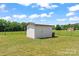 A backyard outbuilding, perfect for extra storage, sits on a spacious lot with a well-maintained lawn at 233 Sellars Rd, Kings Mountain, NC 28086