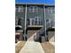 Rear exterior view showing garage and private balcony space, perfect for relaxing outdoors at 3007 Citizens Ln, Charlotte, NC 28205