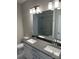 Elegant bathroom featuring dual sinks, a large mirror, and modern fixtures at 3007 Citizens Ln, Charlotte, NC 28205