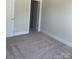 An inviting bedroom with neutral walls, plush carpeting, and ample natural light at 3007 Citizens Ln, Charlotte, NC 28205