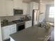Modern kitchen featuring stainless steel appliances, gray countertops, and white cabinetry at 3007 Citizens Ln, Charlotte, NC 28205