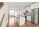Bright, open-concept kitchen featuring a large island, stainless steel appliances, and hardwood floors at 3007 Citizens Ln, Charlotte, NC 28205