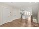 Hardwood floors with plenty of open space in a light-filled living area, staircase leading to other floors at 3007 Citizens Ln, Charlotte, NC 28205