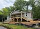 New construction home featuring gray siding, a covered porch, and wooden stairs leading to the front entrance at 32874 Old Salisbury Rd, Albemarle, NC 28001