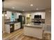 Bright kitchen featuring stainless appliances, white cabinets, and a functional island at 32874 Old Salisbury Rd, Albemarle, NC 28001