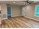 Inviting living room with wood-look floors, fresh paint, and a modern ceiling fan at 32874 Old Salisbury Rd, Albemarle, NC 28001