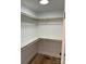 This walk-in closet offers spacious storage with wooden rails and shelving at 32874 Old Salisbury Rd, Albemarle, NC 28001