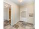 Hallway featuring checkered floors with neutral painted walls and multiple entryways, offering connectivity throughout the space at 3585 Woodstream Dr, Maiden, NC 28650