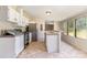 Open kitchen features a breakfast bar, tile floors, stainless steel refrigerator, and lots of natural light at 3585 Woodstream Dr, Maiden, NC 28650