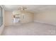 Spacious living room with ceiling fan and view into the kitchen area at 3585 Woodstream Dr, Maiden, NC 28650
