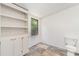 Storage room with built in shelving, cabinetry, checkered floors, and natural light, offering functionality and organization at 3585 Woodstream Dr, Maiden, NC 28650