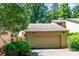 Attached garage with a tan door providing secure parking and additional storage space at 4025 Ivystone Ct, Charlotte, NC 28277