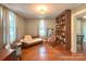 Sunlit bedroom with hardwood floors, built-in shelving, and neutral decor at 436 8Th Avenue Nw Dr, Hickory, NC 28601