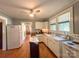 Well-lit kitchen with white cabinets, practical layout, and hardwood floors at 436 8Th Avenue Nw Dr, Hickory, NC 28601