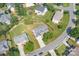 Aerial view of the home in a mature neighborhood with a long driveway and lush, mature trees at 4392 Sunset Rose Dr, Fort Mill, SC 29708