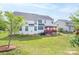 Beautiful backyard showcasing the home's exterior and a well-manicured lawn, great for outdoor activities at 4392 Sunset Rose Dr, Fort Mill, SC 29708