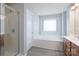 Bright bathroom featuring a shower, soaking tub, and ample natural light at 4392 Sunset Rose Dr, Fort Mill, SC 29708