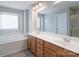 Spacious bathroom featuring double sinks, a soaking tub, and a large mirror at 4392 Sunset Rose Dr, Fort Mill, SC 29708