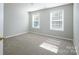 Neutral bedroom with carpet and two windows bringing in plenty of natural light at 4392 Sunset Rose Dr, Fort Mill, SC 29708