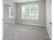 Spacious bedroom boasts neutral paint, carpeted floors, and abundant natural light through two large windows at 4392 Sunset Rose Dr, Fort Mill, SC 29708