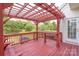 A relaxing outdoor deck with pergola, features a built-in table and comfortable seating for outdoor enjoyment at 4392 Sunset Rose Dr, Fort Mill, SC 29708