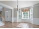 Elegant dining room featuring hardwood floors, crown molding, and large windows for ample natural light at 4392 Sunset Rose Dr, Fort Mill, SC 29708