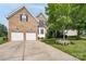 Charming brick home featuring an attached two-car garage and a well-manicured front yard with mature trees at 4392 Sunset Rose Dr, Fort Mill, SC 29708