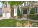 Inviting brick home entrance with double doors, manicured landscaping, and a two-car garage at 4392 Sunset Rose Dr, Fort Mill, SC 29708